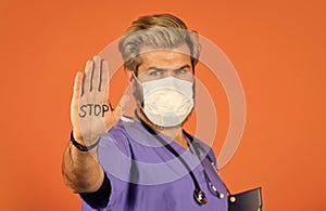 Danger zone. Man in medical lab. Protective mask. Open palm stop gesture. Stop epidemic. Virus concept. Epidemic