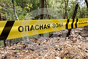 Danger zone sign in cyrillic.Warning sign in the forest