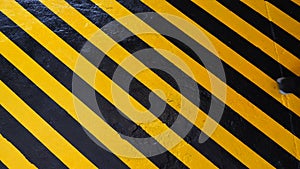 Danger zone sign on floor. Man walking across yellow-black Industrial safety area inside factory. Stripes of warning