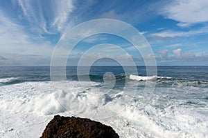 Dangerious ocean stormy waves hits black lava rocks by Faro de las Hoyas, La Palma island, Canary, Spain