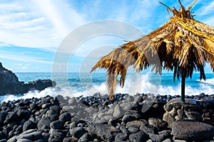 Dangerious ocean stormy waves hits black lava rocks on Playa de la Bombilla, La Palma island, Canary, Spain