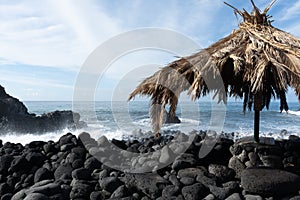 Dangerious ocean stormy waves hits black lava rocks on Playa de la Bombilla, La Palma island, Canary, Spain