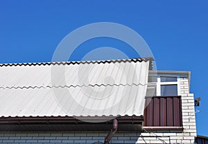 Dangerous asbestos new roof tiles with roof window, dormer and small balcony