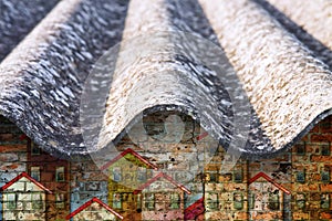 Dangerous asbestos roof - one of the most dangerous materials in the construction industry - concept image with buildings