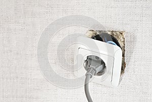 Dangerous bad,broken socket,plug in bathroom,falling out of wall. Outlet installation in old apartment. Poor electrical