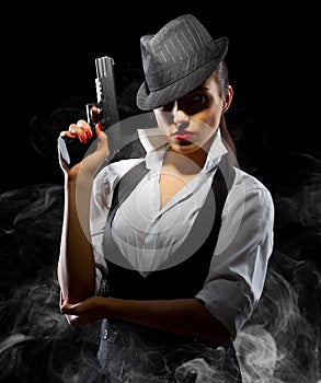 Dangerous and beautiful criminal girl with gun