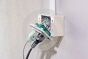 Dangerous broken electrical socket falling out of wall