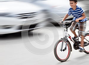 Dangerous city traffic situation with a boy on bicycle