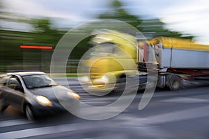 Dangerous city traffic situation between a car and a truck in motion blur