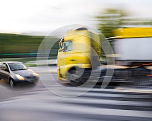 Dangerous city traffic situation between a car and a truck in motion blur