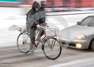 Dangerous city traffic situation with cyclist and car in the city road in motion blur