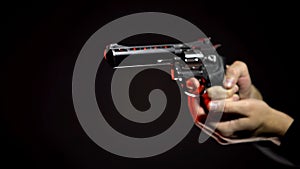 Dangerous contract killer aiming gun isolated on black background, crime