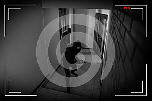 Dangerous criminals with weapon in hallway, view through CCTV camera