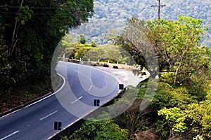 Dangerous curve in the mountain with Atlantic forest vegetation.