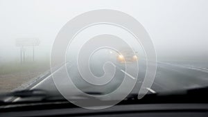 Dangerous driving on road in fog