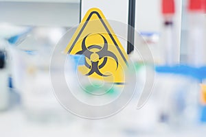 Dangerous drug warning sign biohazard,experimental concept treatment coronavirus or covid 19,medicine and vaccine in glass bottle