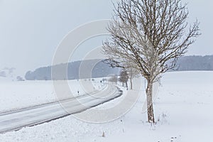 Dangerous empty snowy icy winter road track with no traffic