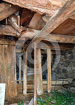 Dangerous entrance to an abandoned mine with unsafe wooden plank