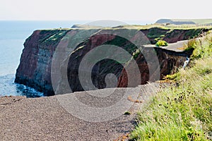 Dangerous eroded cliff road at Staithes in Yorkshire.