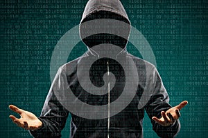 Dangerous hacker over abstract digital background with binary code. Obscured dark face in mask and hood. Data thief