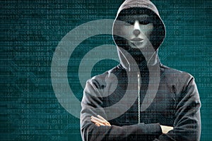 Dangerous hacker over abstract digital background with binary code. Obscured dark face in mask and hood. Data thief