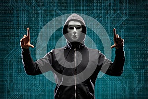 Dangerous hacker over abstract digital background with binary code. Obscured dark face in mask and hood. Data thief