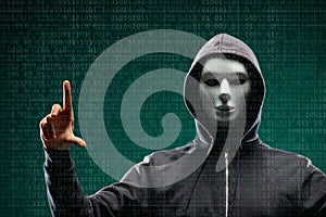 Dangerous hacker over abstract digital background with binary code. Obscured dark face in mask and hood. Data thief