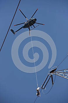 Dangerous High Voltage Power Line Work From A Helicopter