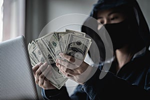 Dangerous Hooded Hacker held the money after successfully hacking