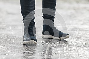 Dangerous icing on the sidewalk, slippery road