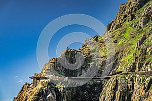 Dangerous landing on the edge of cliff of Skellig Michael island where Star Wars were filmed