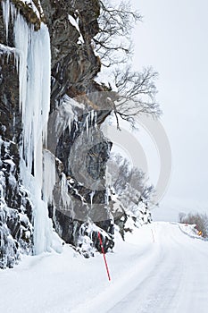 Dangerous large ice mirrors near a snowy road