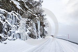 Dangerous large ice mirrors near a snowy road