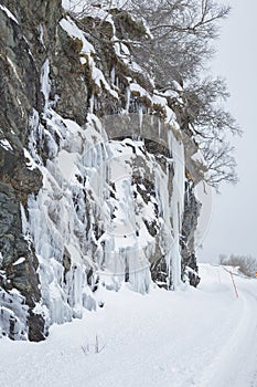 Dangerous large ice mirrors near a snowy road