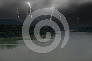 Dangerous lightning with black monsoon clouds cover the earth