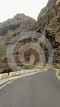 a dangerous mountain road with a steep turn