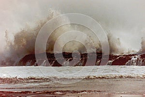 dangerous ocean waves break surf rock photo