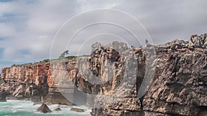 Dangerous ocean waves crash into cliff, Devil Mouth Boca do Inferno, Portugal