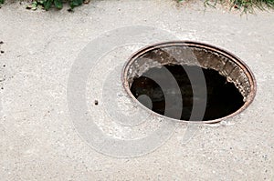 Dangerous opened manhole hole cover, danger for people who walking on the street in the city