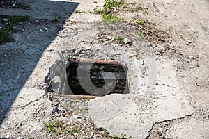 Dangerous opened manhole hole cover, danger for people who walking on the street in the city