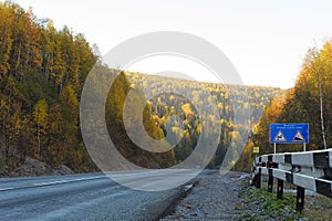 Dangerous road descent in autumn forest