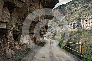 Dangerous road in mountain gorge, falling rocks