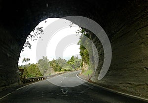 Dangerous road through tunnel carved out of mountain of rock