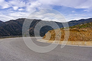 Dangerous serpentine road, low visibility turn in high mountains