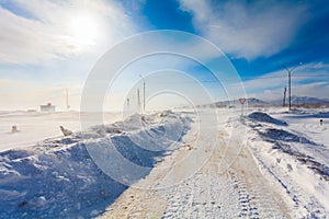 Dangerous snowing road with road signs for driving cars and public transport during blizzard