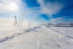 Dangerous snowing road with road signs for driving cars and public transport during blizzard