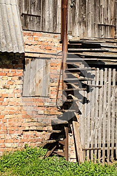 Dangerous spiral wooden stairs without railings at the barn