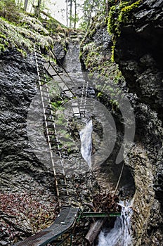 Dangerous trail  across waterfall  using Via Ferrata, Slovak Paradise National Park