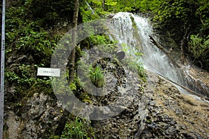 Dangerous trail through a waterfall with steel ladders in the Slovak Paradise National Park, Slovaki