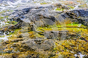 Dangerous underwater rock on beach at low tide. Costa Brava, Spain